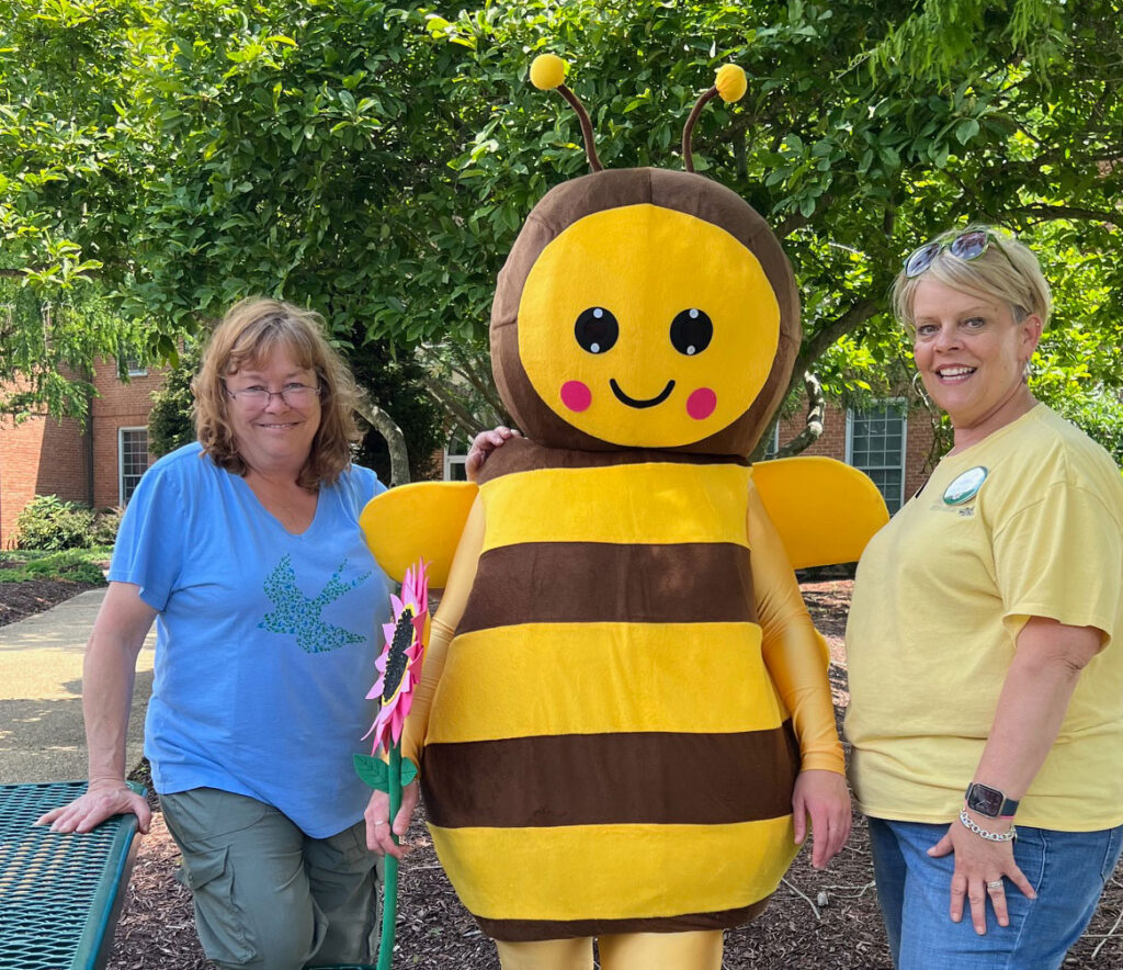 Lynne Wheeler (left) and Toni Kruszka (right) with Polly the Pollinator at Nature Fest, May 2025.